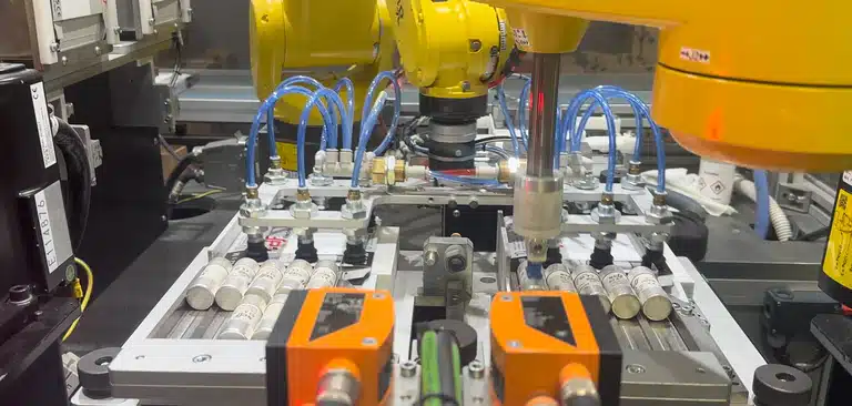 Robots handling fuses on our automated assembly line
